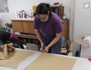 Alexandra Hetrick cutting material for dance dresses in Nanwalek.